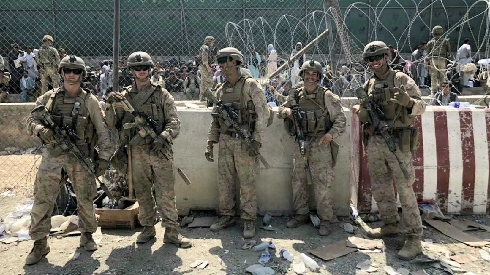 U.S. Marines with Golf Company, 2nd Platoon, 1st Marine Division, pose for a photograph at Hamid Karzai International Airport